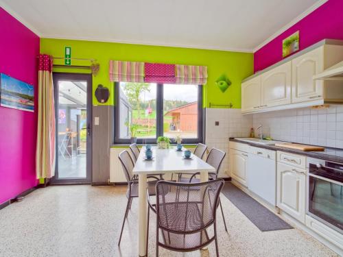 a kitchen with a white table and chairs at Holiday Home in Lierneux with Private Garden in Lierneux