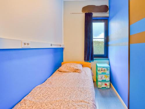 a small bedroom with a bed and a window at Holiday Home in Lierneux with Private Garden in Lierneux