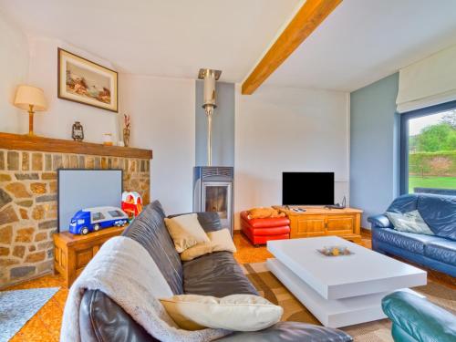 a living room with a couch and a fireplace at Holiday Home in Lierneux with Private Garden in Lierneux