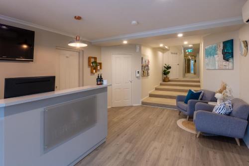 a living room with a tv and a fireplace at Lifestyle Apartments at Ferntree in Fern Tree Gully