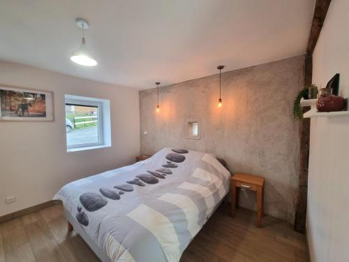 a bedroom with a large bed in a room at Gîte Chaleureux 8 Pers. avec Animaux Admis - FR-1-496-343 in Pouilly-les-Feurs