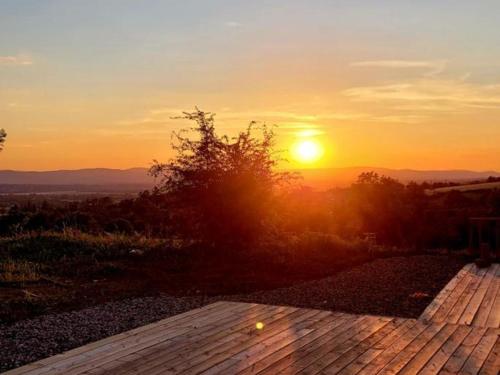a sunset with the sun setting in the distance at Gîte Chaleureux 8 Pers. avec Animaux Admis - FR-1-496-343 in Pouilly-les-Feurs