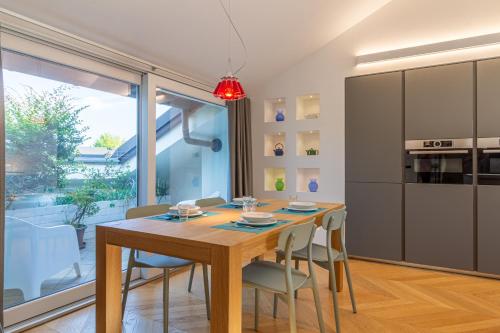 a dining room with a wooden table and chairs at My cup of tea in Seregno