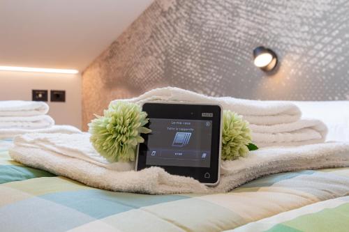 a tablet on a blanket on a bed with towels at My cup of tea in Seregno