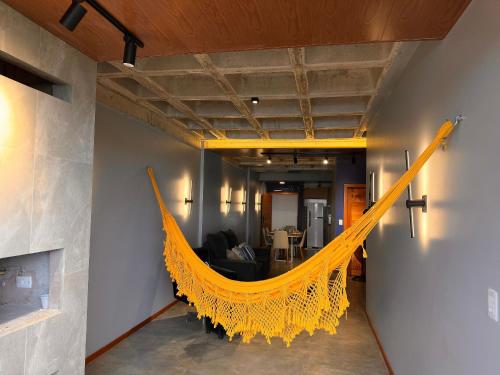 a yellow hammock hanging from a wall in a room at Chão de estrelas|vista701 in Alter do Chao