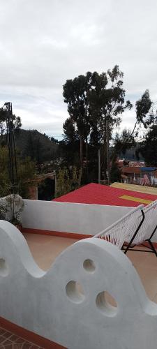 a white object sitting on top of a roof at Jardín Andino Hostal in Copacabana