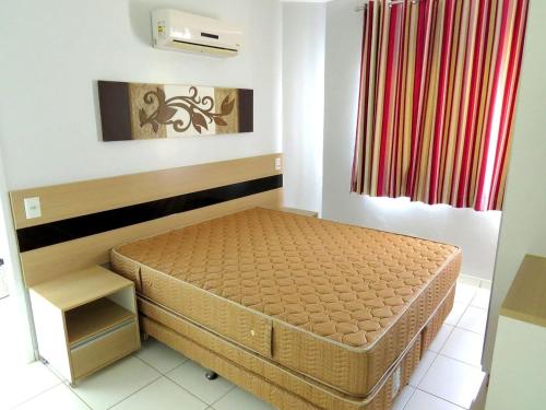 Ένα ή περισσότερα κρεβάτια σε δωμάτιο στο Apartamentos Lagoa Flat Service