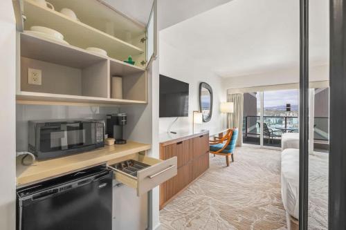 a room with a kitchen and a bedroom with a bed at Top Floor Studio with Balcony & Views 3528 in Honolulu