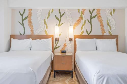 two beds sitting next to each other in a hotel room at Top Floor Studio with Balcony & Views 3528 in Honolulu