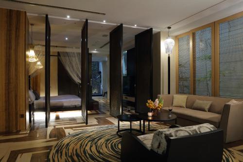 a living room with a couch and a table at Mulan Motel in Taichung