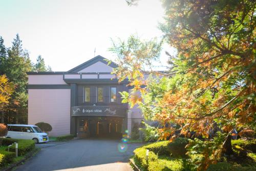 a house with a car parked in front of it at Hotel Aqua Vitae (Adult Only) in Nasu
