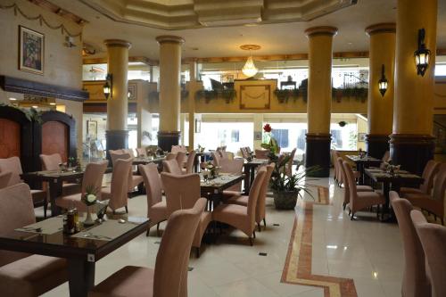 a restaurant with tables and chairs in a room at Massara House Al Khobar in Al Khobar