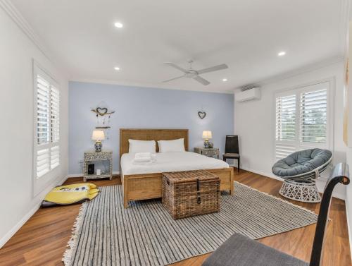 a bedroom with a bed and a chair at Seascape - Pet Friendly in Kingscliff