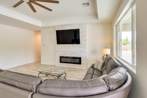 a living room with a couch and a fireplace at Patio and Fenced-In Yard Desert Oasis in Pahrump! in Pahrump