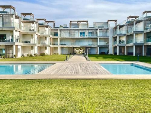an apartment building with a pool in front of it at New Luxury Apartment, Sea View with Pool & Gym in Nazaré
