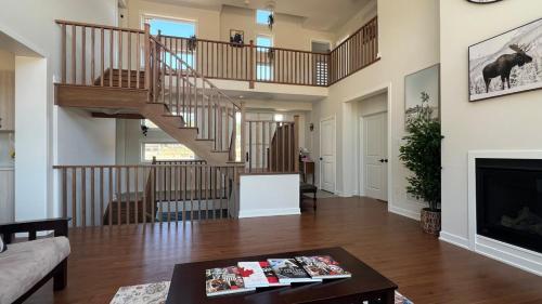 a living room with a staircase and a fireplace at Entire Home in Lake of Bays -Huntsville Muskoka Algonquin in Dwight