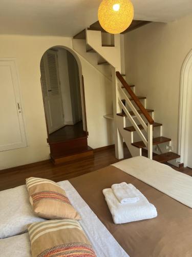 a room with a bed with a mirror and a staircase at Casita de Ocharan Miraflores a dos calles de Larcomar in Lima