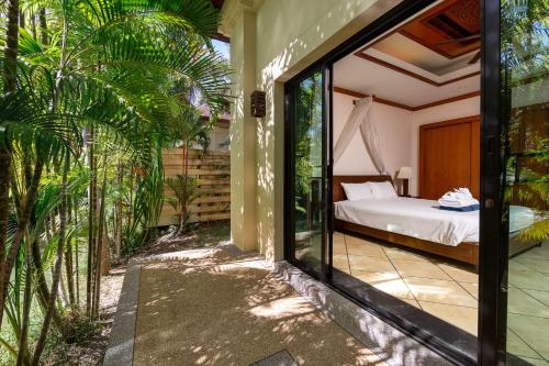 a bedroom with a bed in a room at Villa Hoata| Luxury 2BR villa in the Baan Bua Estate | Nai Harn beach in Nai Harn Beach