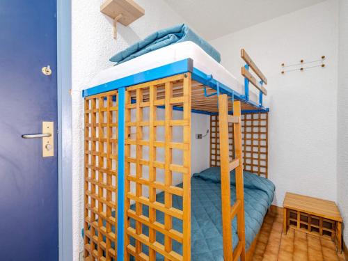 a bunk bed in a room with a blue bed at Studio vue mer avec Wi-Fi pour 4, Roquebrune-Cap-Martin - FR-1-827-92 in Roquebrune-Cap-Martin