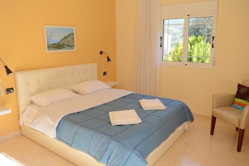 1 dormitorio con 1 cama con 2 toallas en Villa Basilika, en Vlorë