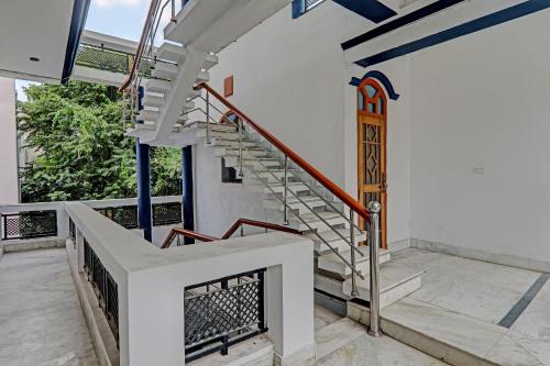 a spiral staircase in a house with a window at 81603 Hotel Shiva Grand in Chinhat