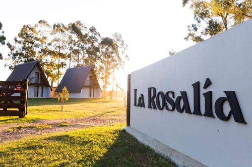 a sign for la rosella logo in front of a building at Cabañas La Rosalía in Chajarí