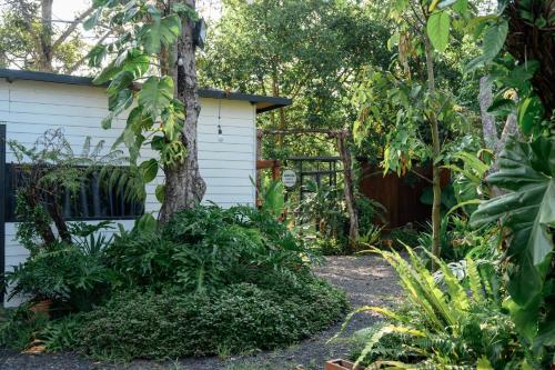 a garden in front of a white house at Dancasa Horse Farm & Homestay in Buôn Chiêt