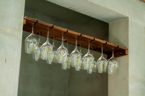 a bunch of glass bottles hanging from a beam at Kampot Sweet Boutique in Kampot