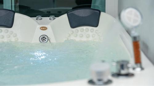 a white bathroom sink with water in it at Gyeongju Modern Pool Villa in Gyeongju