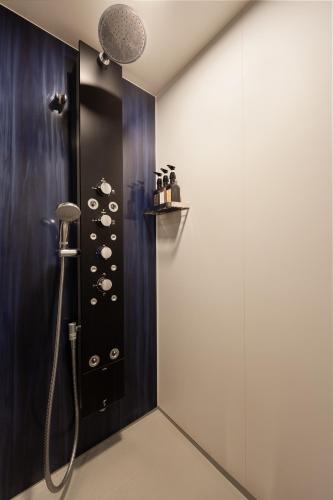 a bathroom with a shower with a shower head at Hotel Oriental Express Kagoshima Tenmonkan in Kagoshima