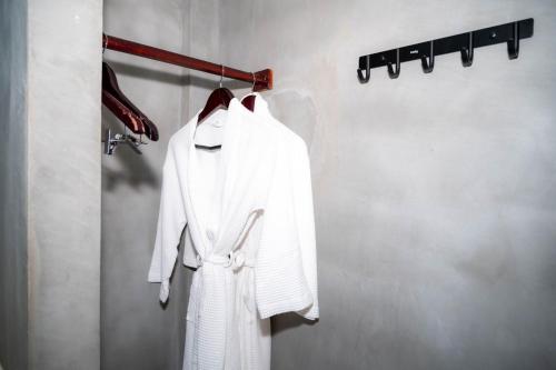 a white robe is hanging on a rack at Kampot Sweet Boutique in Kampot