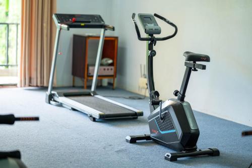 a room with two exercise bikes and a treadmill at Kampot Sweet Boutique in Kampot