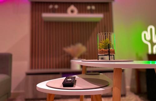 a remote control sitting on top of two tables at Chic, Central Haven, Games, Balcony Zen, 2BR in Midland