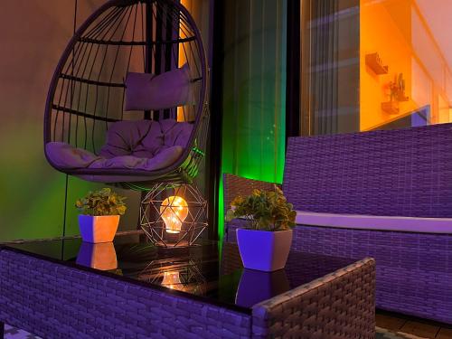 a bird cage with a chair and potted plants at Chic, Central Haven, Games, Balcony Zen, 2BR in Midland