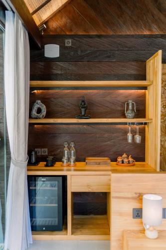 a kitchen with wooden walls and a wooden counter top at Villa Bolon in Kuta