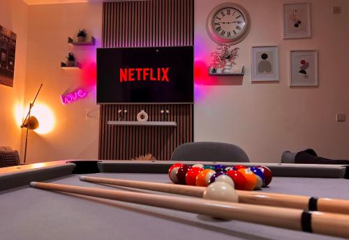 a ping pong table in a room with a netflix sign at Chic, Central Haven, Games, Balcony Zen, 2BR in Midland