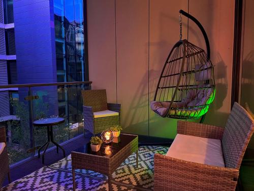 a balcony with a chair and a bird cage at Chic, Central Haven, Games, Balcony Zen, 2BR in Midland