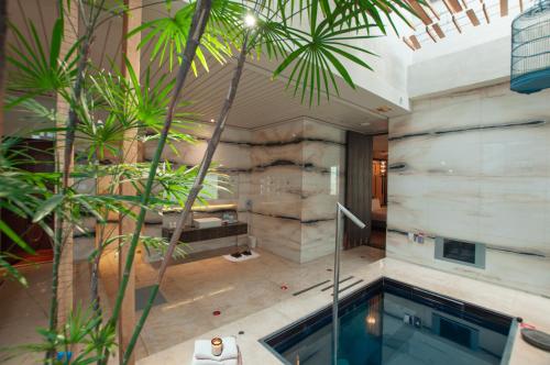 a house with a swimming pool and palm trees at Mulan Motel in Taichung