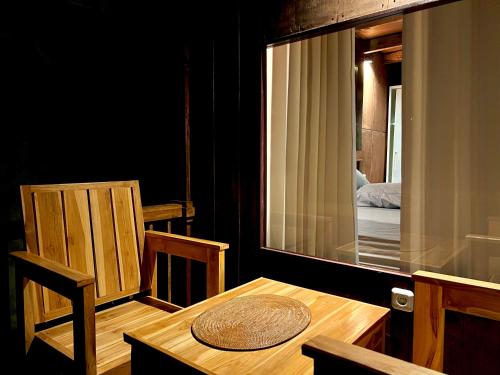a room with a table and chairs and a mirror at Nona Lodge in Tetebatu