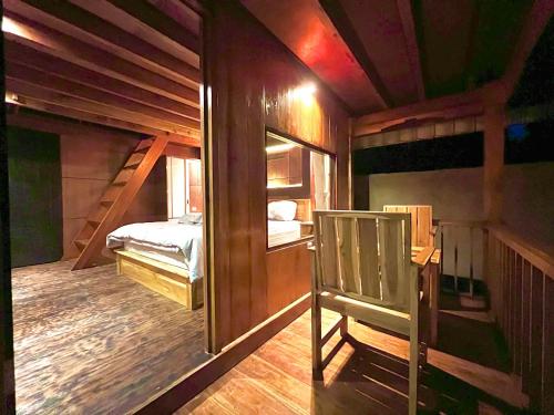 a room with a bed and bunk beds in it at Nona Lodge in Tetebatu