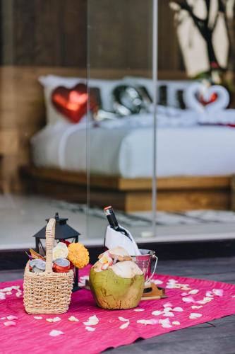 a table with a plate of food and a bed at Villa Dijabu in Kuta