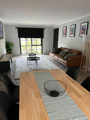 a living room with a table and a couch at Inverloch Palm Waters 5 in Inverloch
