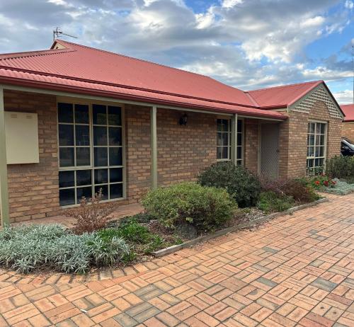 a brick house with a red roof and a brick driveway at Inverloch Palm Waters 5 in Inverloch