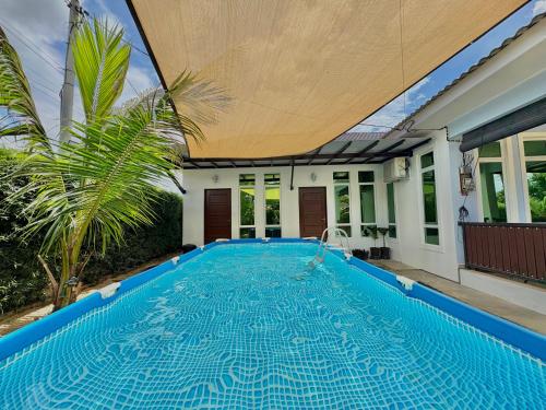 a swimming pool in the backyard of a house at Tepak Nusuk Private Pool Homestay 5 Bedrooms 4 Bathrooms in Kota Bharu