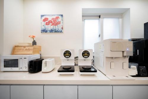 a kitchen counter with two coffee machines on it at Comport Hotel in Pohang