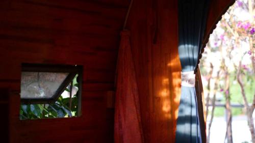 a window in a room with a curtain next to a window at Phố Thường Garden in Da Lat