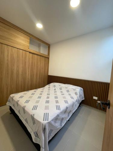 a bedroom with a bed in a room at Cozy apartment in Apartadó in Apartadó