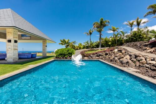 a swimming pool in front of a house with a water fountain at ❤PiH❤ Hale Moana Heated Private Pool Spa Detached Ohana Suite in Waimea