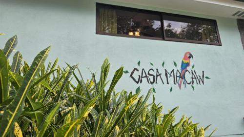 a wall with a painting of a parrot on it at Casa Macaw Jungle Cabin w Private pool Wifi and AC in Quepos