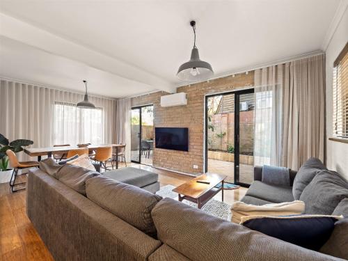 a living room with a couch and a table at Cosy Corner Town Centre in Margaret River Town